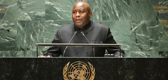 Burundi's president Evariste Ndayishimiye, who recently said LGBTQ+ people 'should be stoned', stands at a podium as he speaks into a microphone