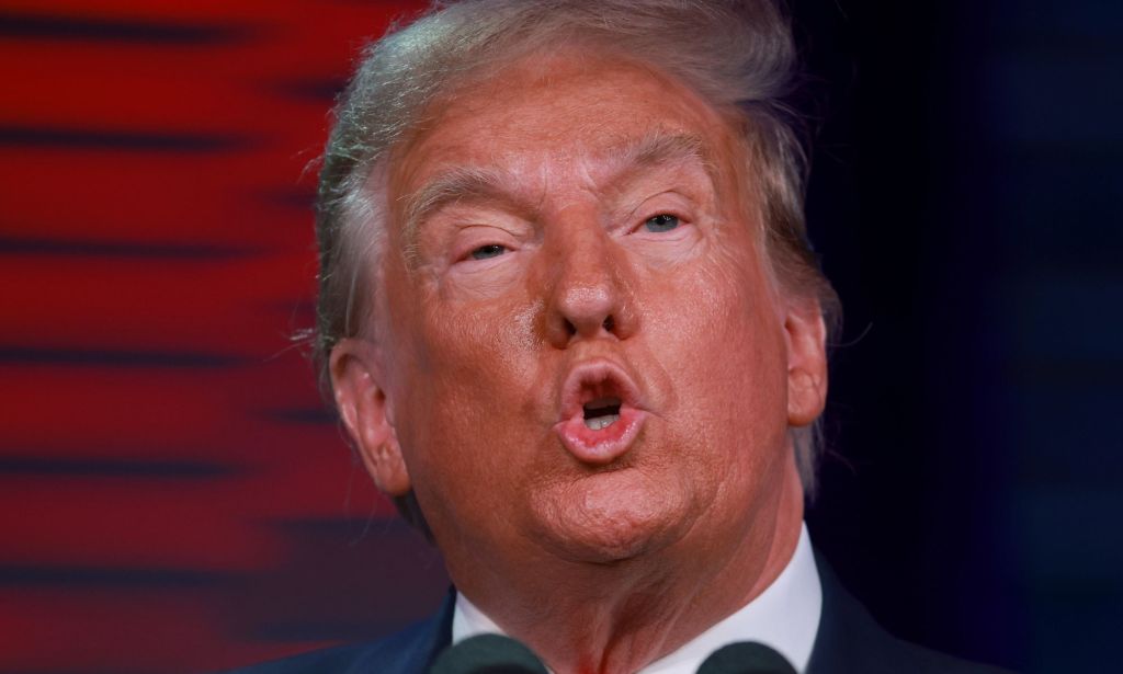 A close up of the fact of president Donald Trump, who has been taken off the Colorado primary ballot after a ruling by the state's supreme court, as he speaks to people off camera