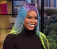 Image shows transgender TV star Amiyah Scott, she is Black and has rainbow coloured hair.