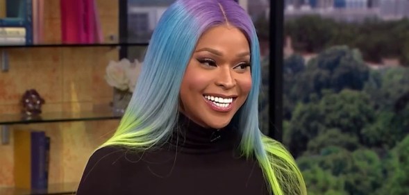 Image shows transgender TV star Amiyah Scott, she is Black and has rainbow coloured hair.