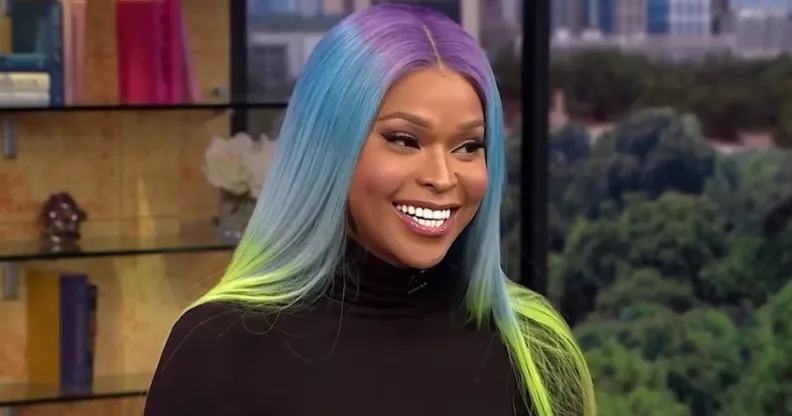 Image shows transgender TV star Amiyah Scott, she is Black and has rainbow coloured hair.