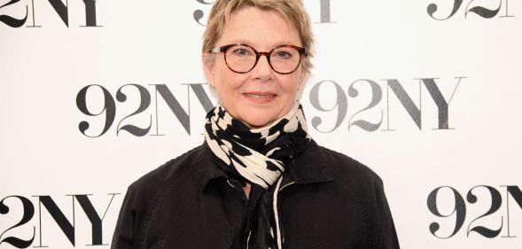 American actress Annette Bening wearing black coat and black-and-white scarf