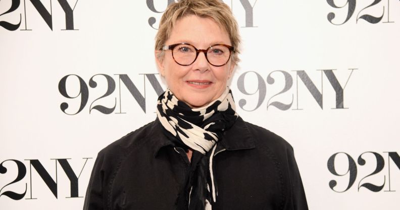 American actress Annette Bening wearing black coat and black-and-white scarf