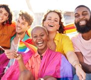 Stock image of a group of Gen Z friends all holding LGBTQ+ Pride flags