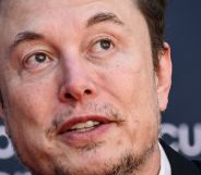 Elon Musk, looking upwards while speaking at an event.