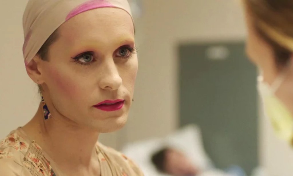 Jared Leto as trans woman Rayon in Dallas Buyers Club wearing make up with a cream and pick scarf over their hair.