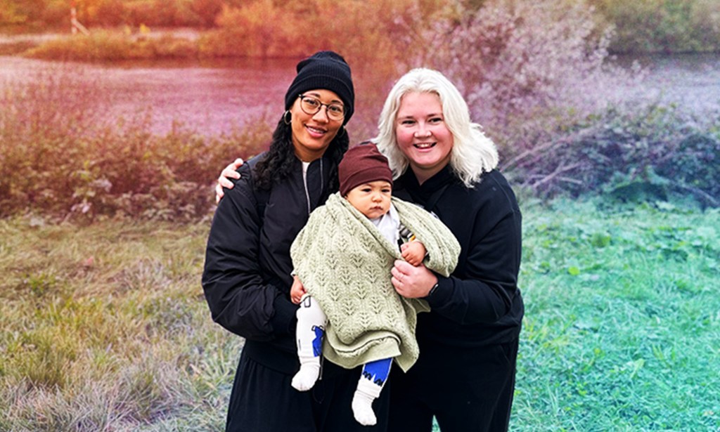 This is an image of two women and their baby.
