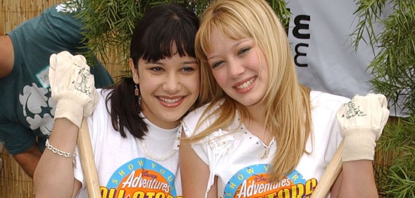 Actresses Lalaine (L) and Hilary Duff (R) of Dinsey's "Lizzie McGuire" volunteer to refurbish the grounds at the Boys and Girls Club of Burbank April 27, 2002 in Burbank, CA.