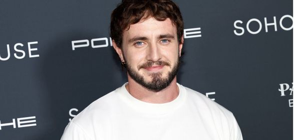 Paul Mescal smiling during a red carpet event.