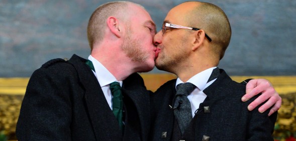 GLASGOW, SCOTLAND - DECEMBER 30: A couple of the same sex Joe Schofield (R) and Malcolm Brown from Tullibody, Clackmannanshire pose for a photograph and will marry at the Trades Hall the ceremony conducted by Ross Wright, from the Humanist Society Scotland shortly after midnight in front of friends and family in one of the first same-sex and belief category weddings in Scotland on December 30, 2014 in Glasgow, Scotland. Same-sex couples have been able to enter into 'civil partnerships' since 2005, however following a change in the law on February 4, 2014. A couple of the same sex are now eligible to marry in Scotland. Parliament's decision to grant same-sex couples an equal right to marriage has been met with opposition from religious groups. (Photo by Mark Runnacles/Getty Images)