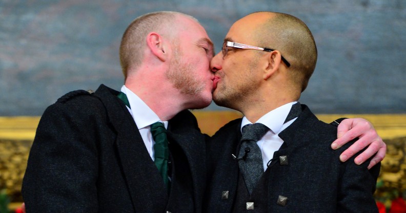 GLASGOW, SCOTLAND - DECEMBER 30: A couple of the same sex Joe Schofield (R) and Malcolm Brown from Tullibody, Clackmannanshire pose for a photograph and will marry at the Trades Hall the ceremony conducted by Ross Wright, from the Humanist Society Scotland shortly after midnight in front of friends and family in one of the first same-sex and belief category weddings in Scotland on December 30, 2014 in Glasgow, Scotland. Same-sex couples have been able to enter into 'civil partnerships' since 2005, however following a change in the law on February 4, 2014. A couple of the same sex are now eligible to marry in Scotland. Parliament's decision to grant same-sex couples an equal right to marriage has been met with opposition from religious groups. (Photo by Mark Runnacles/Getty Images)