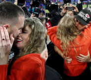 They served some serious PDA on the football field. (Patrick Smith/Getty Images)