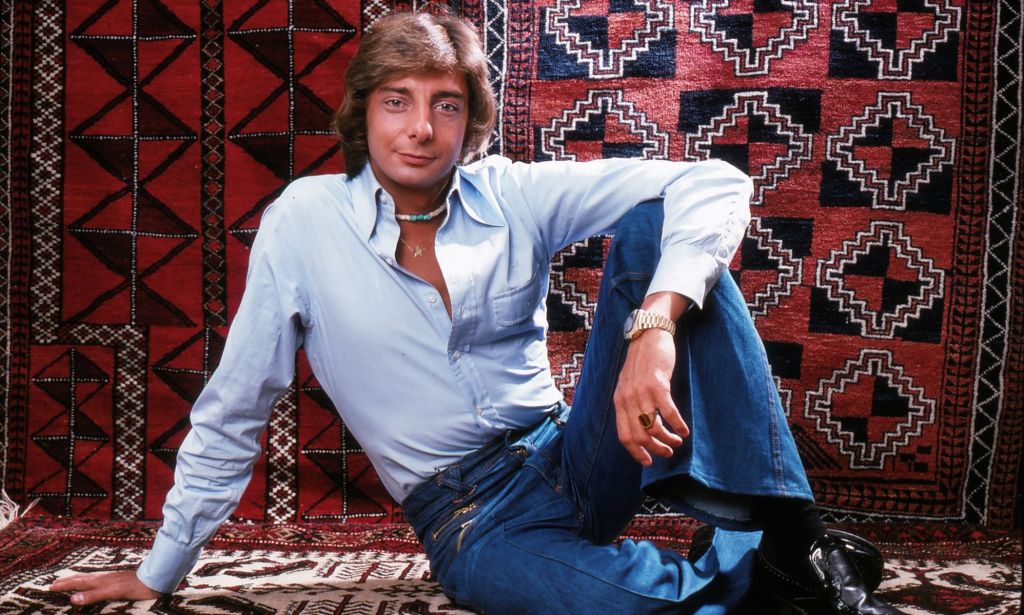 A young Barry Manilow poses with a blue shirt and blue jeans