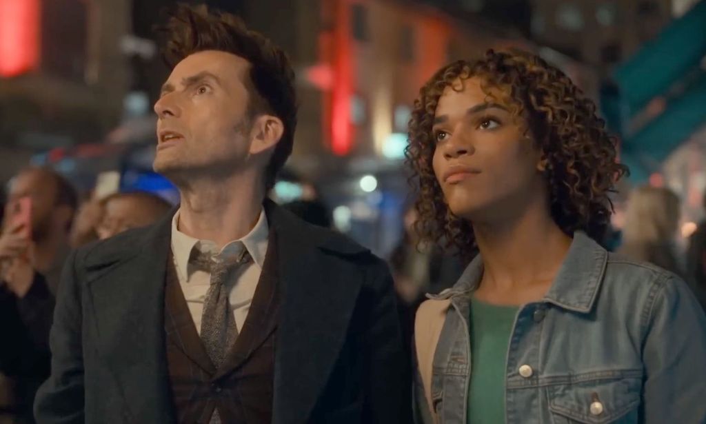 A still from the BBC's Doctor Who special that shows the titular Time Lord (played by David Tennant) standing alongside Rose, a trans character played by Yasmin Finney