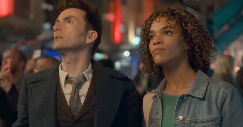 A still from the BBC's Doctor Who special that shows the titular Time Lord (played by David Tennant) standing alongside Rose, a trans character played by Yasmin Finney