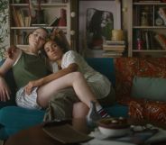 Screenshot of an eHarmony advert shows queer couple sitting together on a sofa hugging