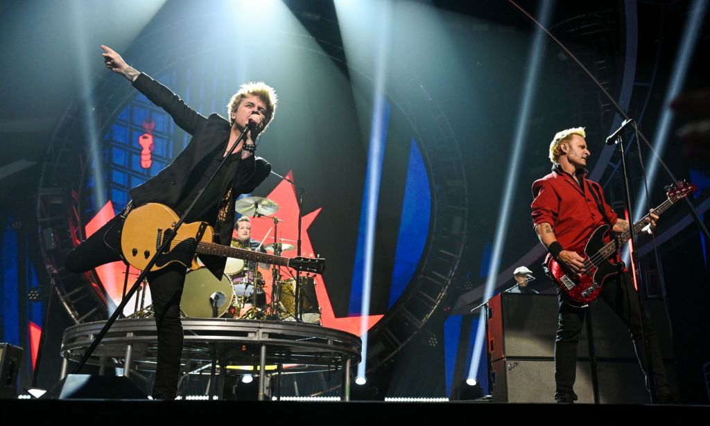 The band Green Day perform onstage during a New Year's Eve concert. During the performance, the band changed the lyrics of their hit song "American Idiot" to slam Donald Trump and his MAGA supporters