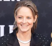 Actor Jodie Foster, who was once offered to play Princess Leia in Star Wars, smiles as she wears a black jacket with sparkly designs on it and a shiny silver necklace