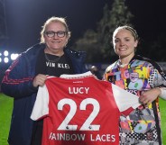 Lucy Clark is presented with a Rainbow Laces Arsenal home shirt by Kim Little, Captain of Arsenal prior to the Barclays FA Women's Super League match between Arsenal and West Ham United at Meadow Park on October 30, 2022 in Borehamwood, England. (Photo by Alex Burstow/Arsenal FC via Getty Images)