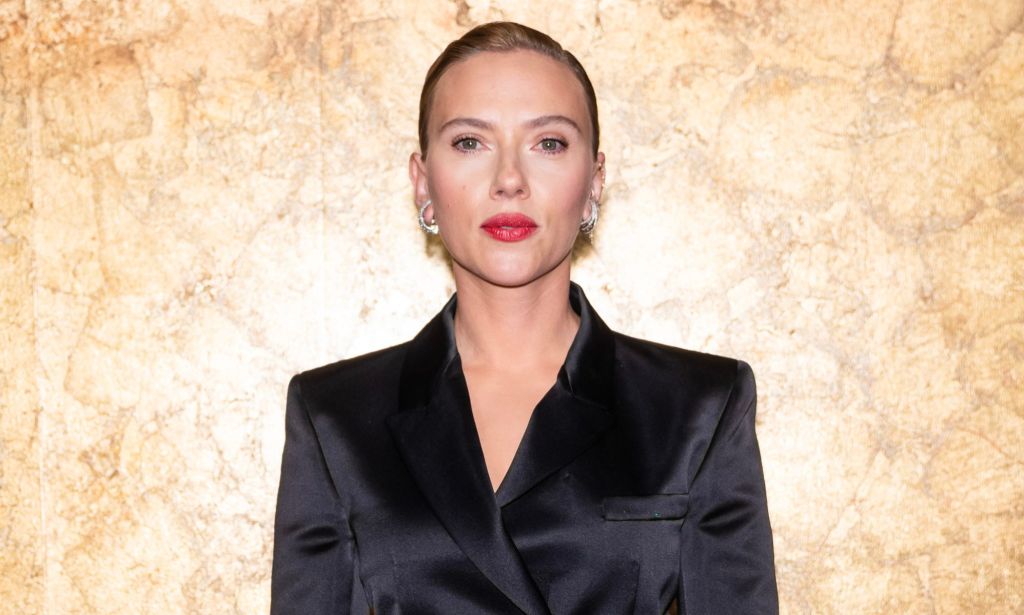 Actor Scarlett Johansson wears a black outfit as she stares towards the camera. Johansson once courted controversy after she defended the decision to play a queer, trans role as a non-LGBTQ+ actor