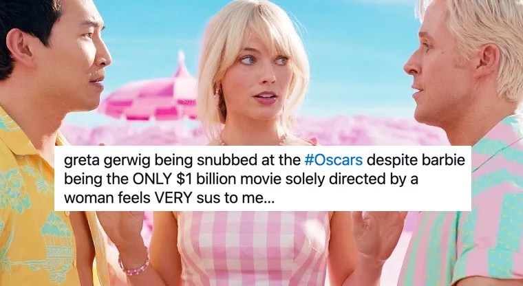 Photo shows a screengrab from the 2023 film Barbie with Margot Robbie standing in between two arguing men (both Kens)