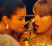 Selena Gomez leans down to talk to Taylor Swift during a now viral interaction at the 2024 Golden Globes
