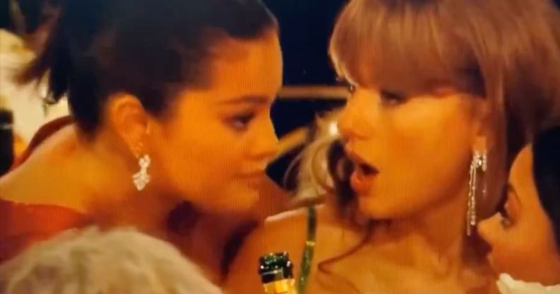 Selena Gomez leans down to talk to Taylor Swift during a now viral interaction at the 2024 Golden Globes