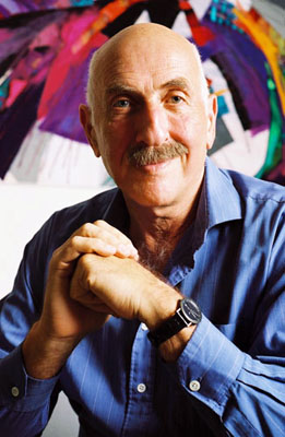 Fritz Klein shown posing in a blue shirt, he's an older man with a balding hairline and moustache.