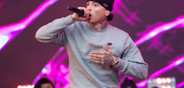 Rapper Central Cee performs on day 2 of Reading Festival 2023 at Richfield Avenue in Reading, England. He is wearing a grey sweatshirt and a black beanie hat. (Photo by Joseph Okpako/WireImage)
