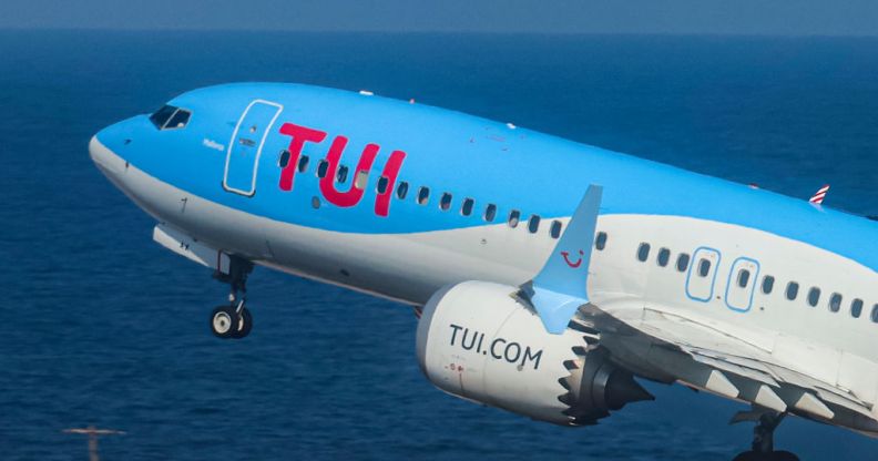 Image shows a plane with TUI branding taking off over the sea