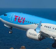 Image shows a plane with TUI branding taking off over the sea