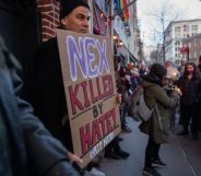 People gather outside the Stonewall Inn for a memorial and vigil for the Oklahoma teenager who died following a fight in a high school bathroom on February 26, 2024 in New York City. Nex Benedict, a 16-year-old who identified as nonbinary and used they/them pronouns, died a day after the altercation in the school bathroom. One protester is holding a sign that says 'Nex, killed by hate'