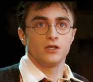 Daniel Radcliffe as Harry Potter looking shocked.