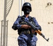 A member of security forces loyal to Yemen's Houthi movement stands guard as armed supporters of the Huthis attend a pro-Palestinian rally in the Huthi-held capital Sanaa on February 7, 2024 amid the ongoing conflict in the Gaza Strip between Israel and the Palestinian militant group Hamas. (Photo by MOHAMMED HUWAIS / AFP)