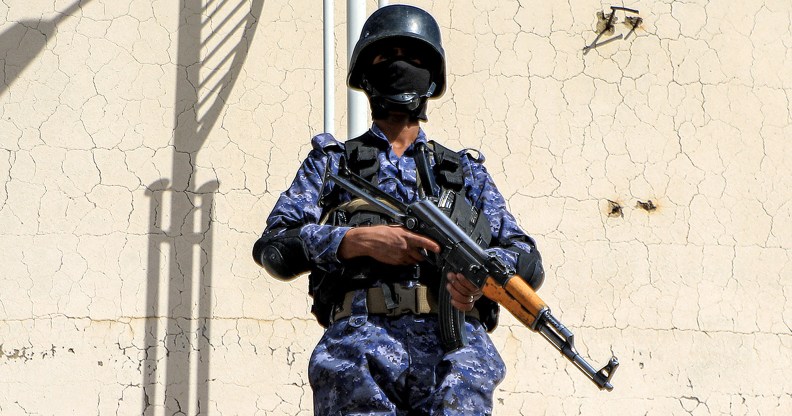 A member of security forces loyal to Yemen's Houthi movement stands guard as armed supporters of the Huthis attend a pro-Palestinian rally in the Huthi-held capital Sanaa on February 7, 2024 amid the ongoing conflict in the Gaza Strip between Israel and the Palestinian militant group Hamas. (Photo by MOHAMMED HUWAIS / AFP)