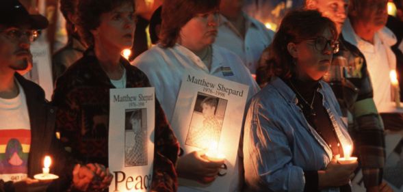 Protestors hold a candlelight vigil for Matthew Shepard.