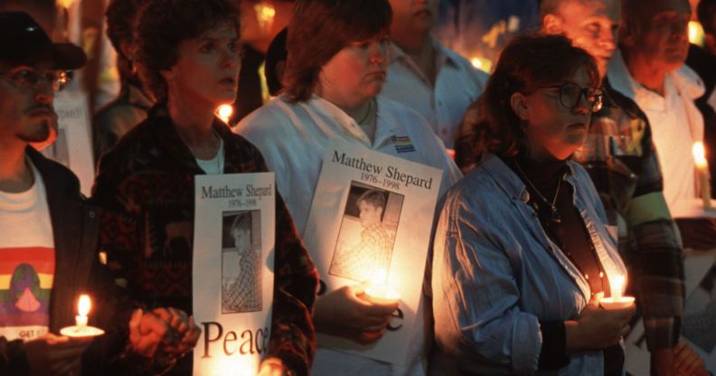 Protestors hold a candlelight vigil for Matthew Shepard.