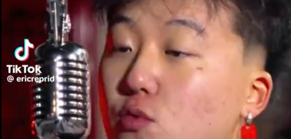 Image shows Canadian Rapper Eric Reprid singing into a microphone