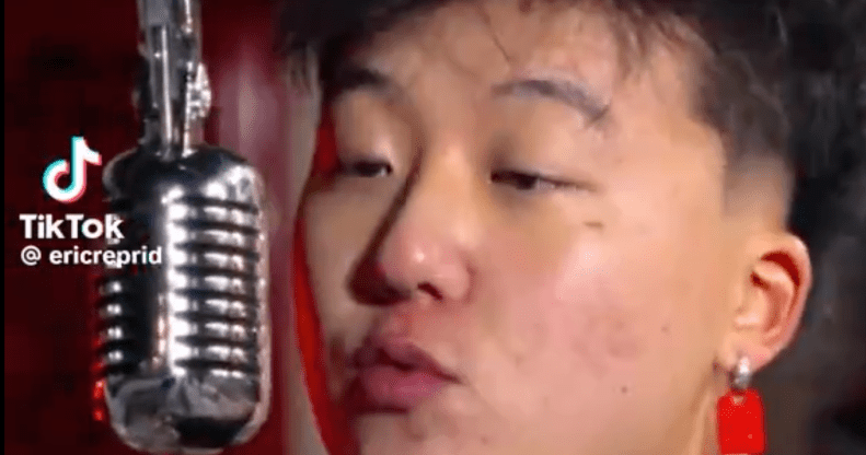 Image shows Canadian Rapper Eric Reprid singing into a microphone