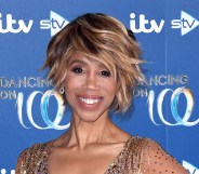 Trisha Goddard on the Dancing on Ice red carpet with a gem studded gown smiling at the camera.