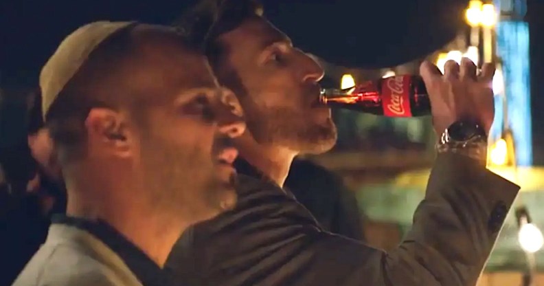 Photo shows two gay dads watching their daughter roller skate.