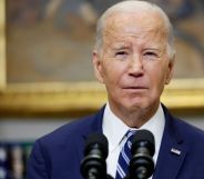 President Joe Biden wears a suit and tie as he stands in front of microphones at the White House