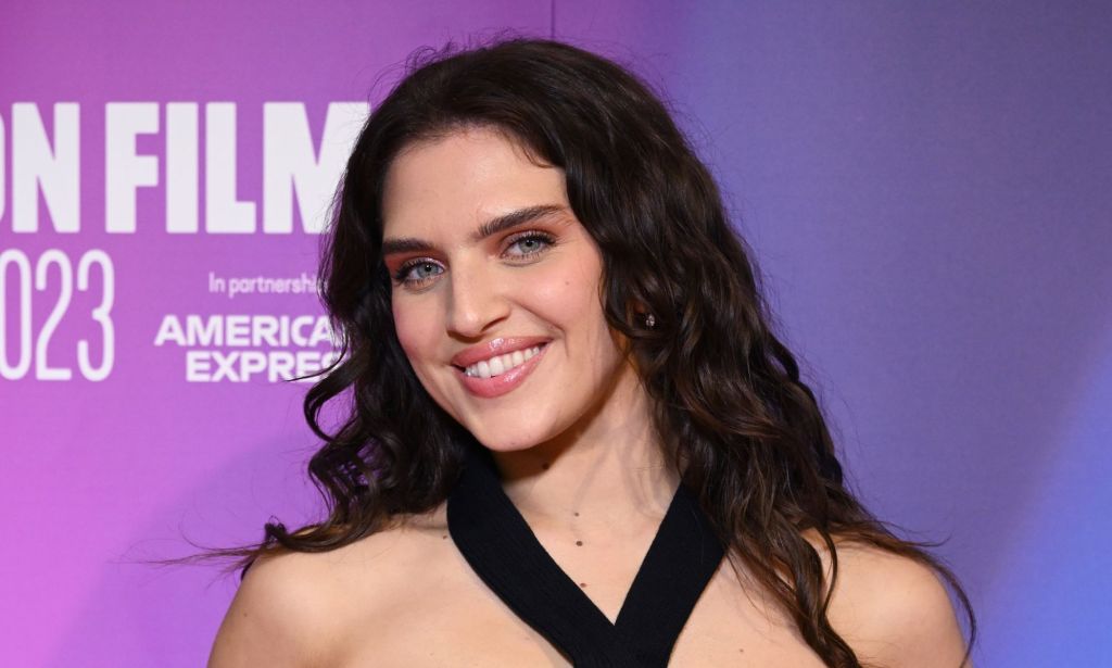 Mae Muller smiles at the premiere for Gassed Up.