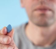 man holding a blue erectile dysfuncrtion viagra pill
