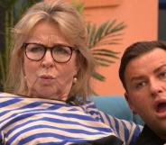Image shows TV presenter Fern Britton and gay reality star David Potts cuddling up on the sofa in the CBB house