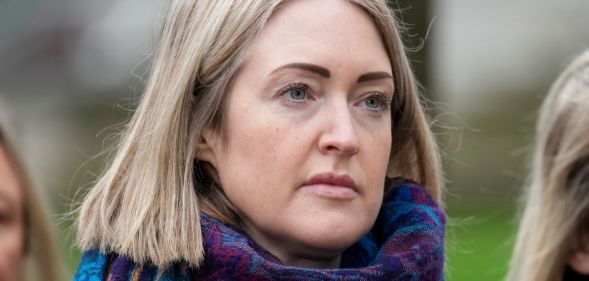 Esther Ghey outside during a vigil, wearing a purple scarf.