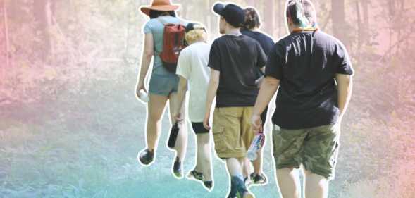 trans campers walking through a forest