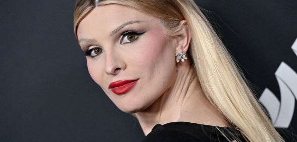 Dylan Mulvaney in a black dress, her hair is dyed blonde