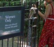 A woman walks through the gate of a women-only pond.