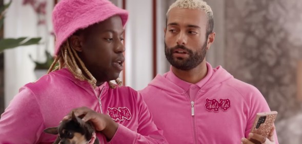 Two men in pink hoodies in the Hilton ad
